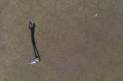 Top view of teen boy practicing golf