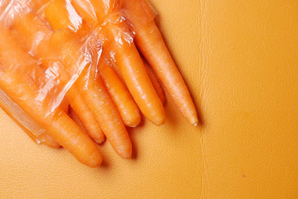 istock fresh carrots in a plastic bag on orange background 1442072971