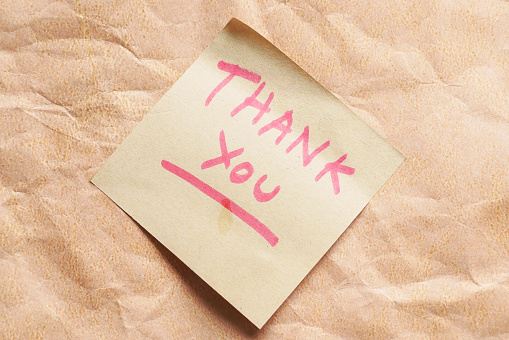 hand written thank you message on sticky note ,