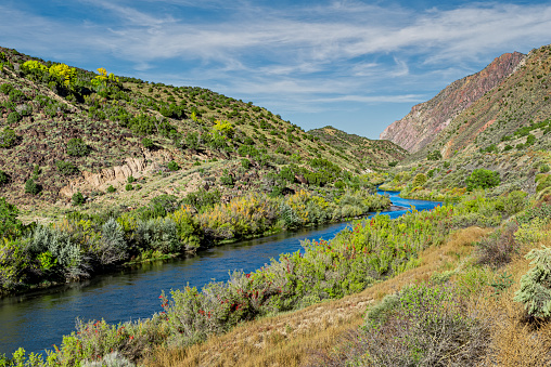 The Rio Grande River originates in the San Juan Mountains of south-central Colorado.  It flows 1,896 miles through Colorado, New Mexico and Texas where it is the international border between the United States and Mexico.  It eventually empties into the Gulf of Mexico.  In northern New Mexico the river flows 50 miles through a tectonic chasm known as the Rio Grande Gorge.  In 2013 the gorge and 242,500 acres of surrounding land was designated as the Rio Grande del Norte National Monument.  This fall scene was photographed in the gorge south of Taos, New Mexico, USA.
