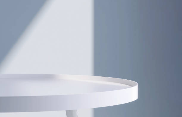 istock Modern and minimal round white pedestal table podium with sunlight and shadow on dark blue wall 1442077246