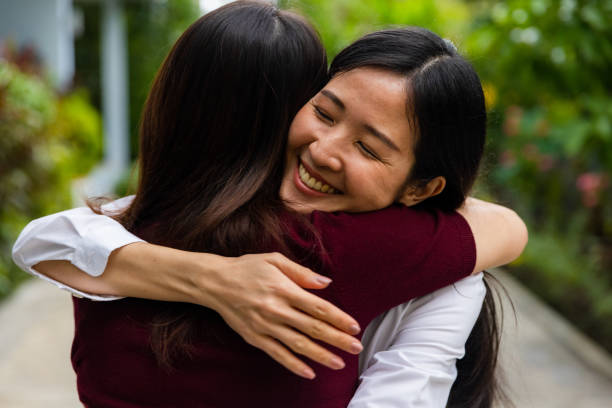 istock Young friends embracing. 1442077345