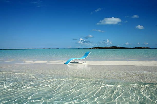 Blue lounger on sand spit in Bahamas stock photo