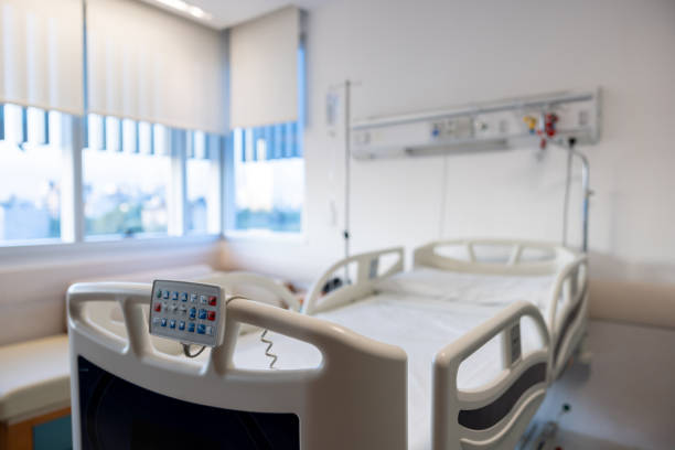 asian woman patient sleeping in hospital for recovery (blur background with wood table top for display or montage your product)