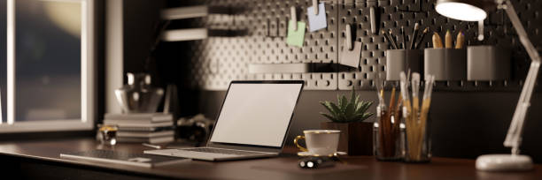 istock Modern urban dark loft office workspace with laptop mockup, table lamp, office supplies 1442079808