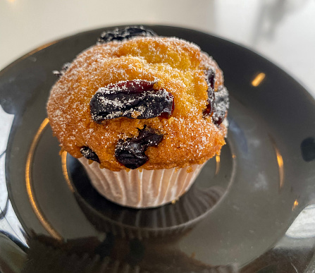 Closed Muffin with raisin topping.