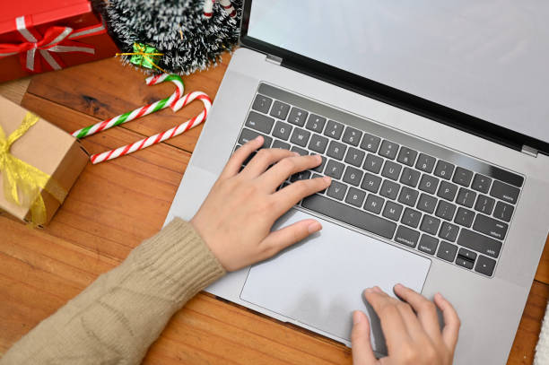 istock Overhead, A female typing on keyboard, using laptop on her workspace with Christmas decor. 1442080494