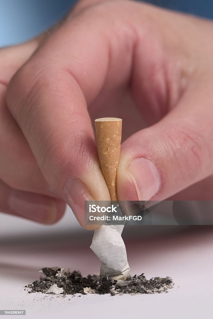 Smoking ban Woman's hand stubbing out a cigarette Cigarette Stock Photo