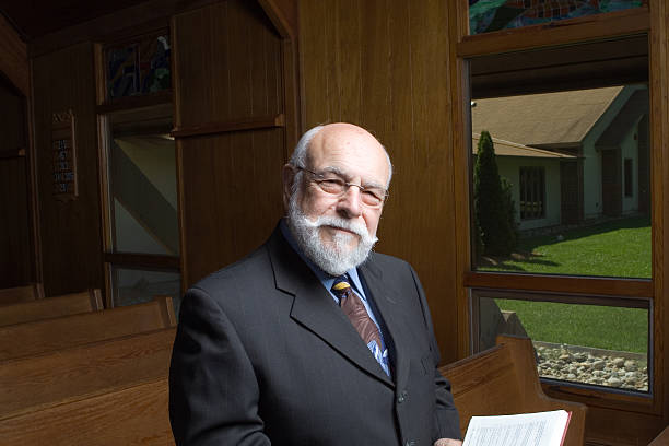 istock Sincere Senior Man Beard Looking at Camera in Church Pew 144209058