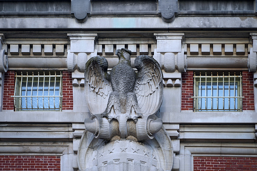American eagle crest, carved out of stone outside the Ellis Island National Museum of Immigration
