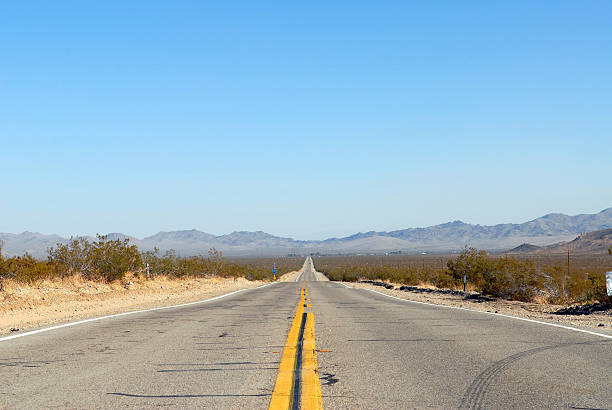 istock Scarred Desert Road, Open Blue Skies 144209944