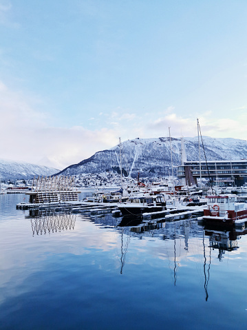 A lot of boats parked at a harbor in Tromso, Norway during winter
