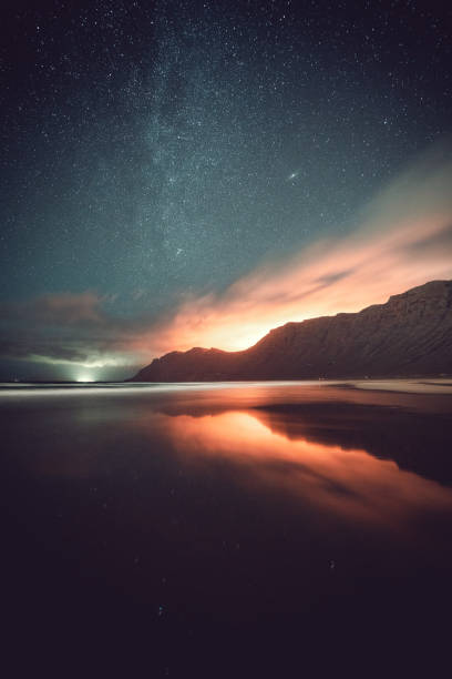 istock Vertical shot of a starry sky over a tranquil sea 1442102140