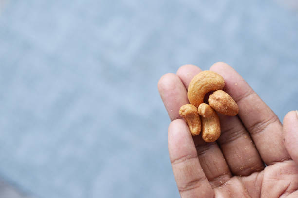 istock cashew nuts on hand top view 1442102323