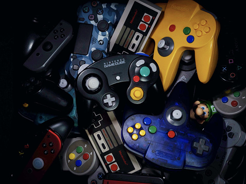 Hamburg, Germany – December 11, 2020: Some controllers for game consoles. Old controllers and new controllers.