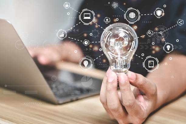 istock Hand holding light bulb with floating digital icons 1442102716
