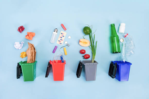 istock Trash bins with assorted garbage on blue background-the concept of recycling and sorting of garbage 1442102865