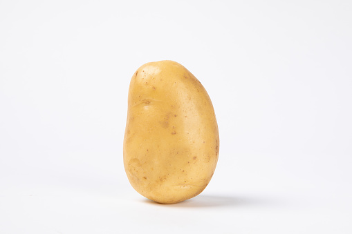 A single fresh raw potato isolated on white background
