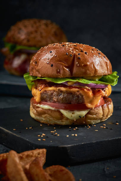 istock Vertical shot of a delicious burger on a blackboard 1442103599