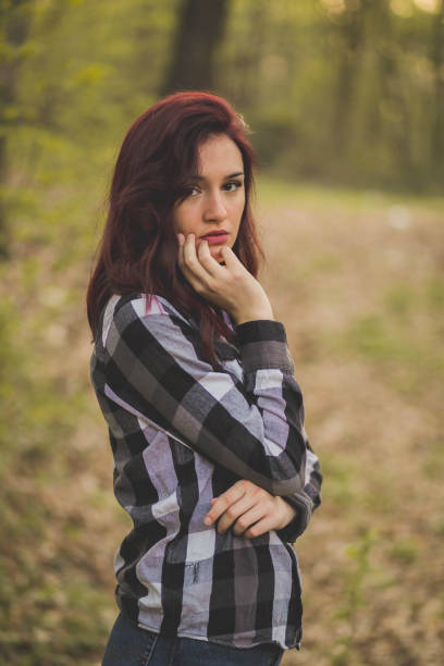 istock Attractive Caucasian female posing for the camera in a forest 1442105376
