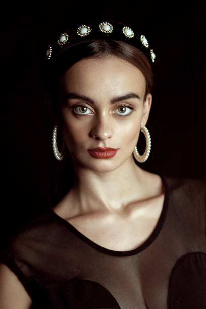 Portrait of a young woman in a swimsuit, wearing a towel, hat, or headband on her head