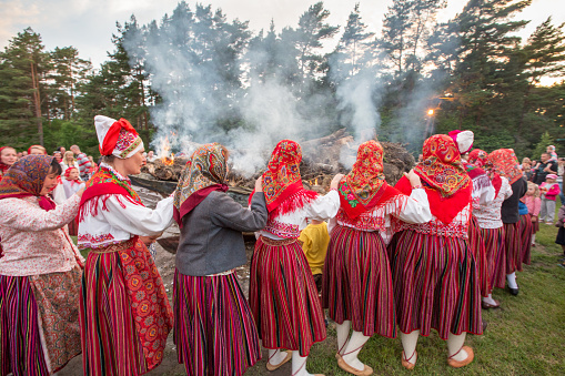 Kihnu island, Pärnu county, Estonia, Europe, Estonia – June 23, 2013: Women's  in Kihnu isl costumes performing ritual dance and song for celebrating the summer  solstice and to respect fishing boat set on fire