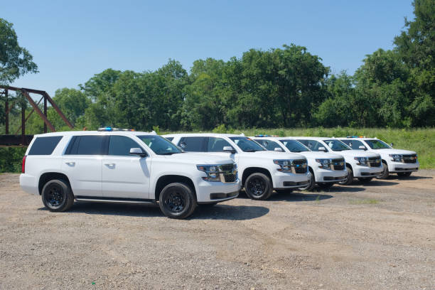 A fleet of White Chevy Tahoe equipped with Feniex Emergency Products Austin, United States – June 19, 2018: Photos of an emergency fleet (White Chevy Tahoe equipped with Feniex Emergency Products). commercial auto insurance fleet stock pictures, royalty-free photos & images