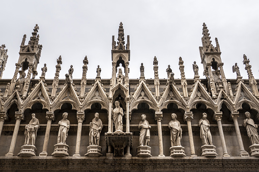 A beautiful view of the Santa Maria Della Spina church side wall with carvings and sculptures in Pisa, Italy