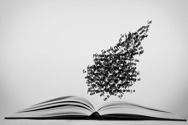 A closeup of an open book with flying words