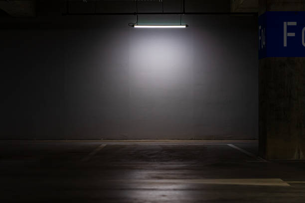 istock Empty parking lot with an overhead dim light, underground parking garage 1442107139