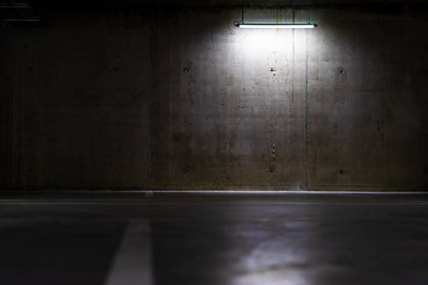 istock Empty parking lot with an overhead dim light, underground parking garage 1442107140
