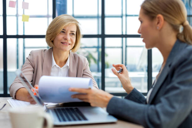 istock Image of two business women working in the office with documents. 1442108673