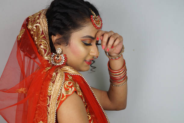 istock Indian bride with a bright makeup wearing a lehenga isolated on a white background 1442109975