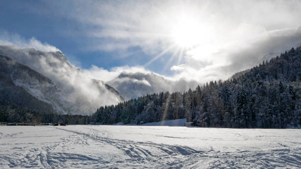 istock Snow covered plain surrounded by mountains and forests. Sunny winter day. Ratece, Slovenia 1442110360