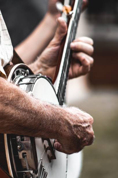 istock Closeup side view of man's hands playing banjo. 1442112266