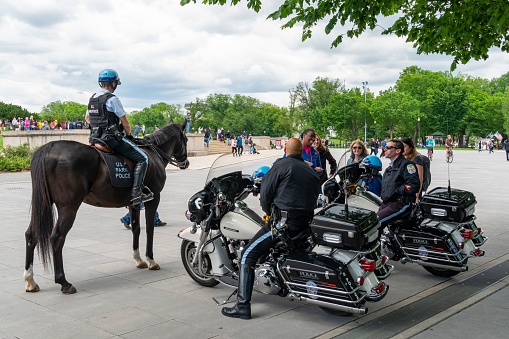 Washington DC, United States – May 14, 2019: Park Police on a horse and motorbikes in Washington D.C., talking to tourists.