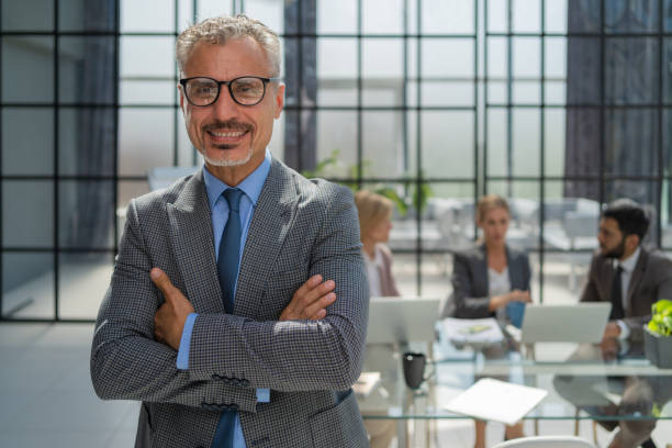 istock Businessman with colleagues in the background in office. 1442113099