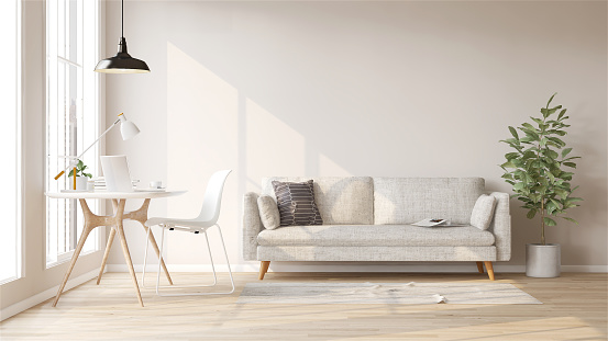 Sofá de tela blanca, planta de higo de hoja de violín, escritorio de trabajo de madera y silla en pared cremosa moderna y lujosa y sala de parquet con luz solar desde la ventana photo