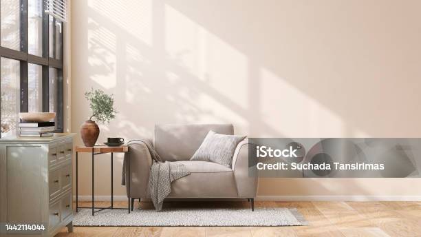 Brown Suede Leather Armchair Brass Side Table And Pastel Green Wooden Cabinet In Modern And Luxury Beige Wall And Rug On Parquet Floor Room With Dappled Sunlight From Window Stock Photo - Download Image Now