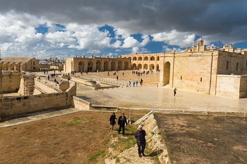 Gzira, Malta – March 08, 2020: Parade ground with visitors, on left the “polverista”, the gunpowder store . Fort Manoel, an 18th century baroque star fort active by 1734.  Malta