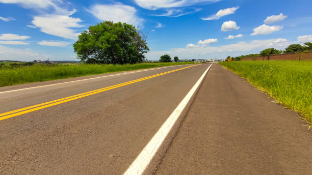 istock Low angle shot of an empty highway under the bright cloudy sky 1442114475