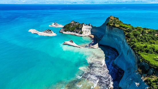 An aerial of Cape Drastis on Corfu Island surrounded by the turquoise water of Ionian sea in Greece