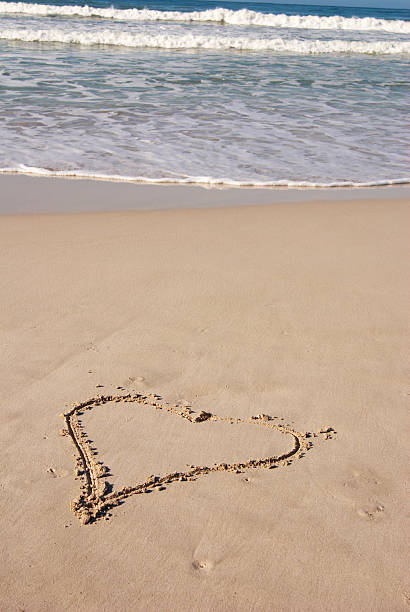 istock Drawing of a heart on sandy beach 144211489