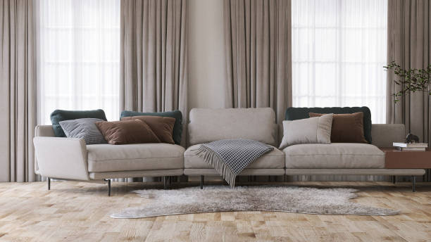 бежевый модульный тканевый диван в современной и роскошной серой стене и ковре на паркетном полу комнаты с солнечным светом от потолка до н - modular стоковые фото и изображения