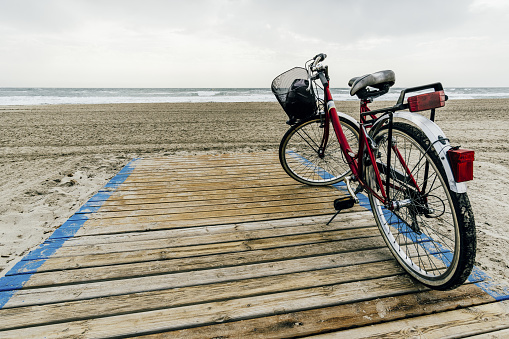 A bicycle on the seaside spit of the La Manga del Mar Menor under the cloudy sky in Murcia city,Spain