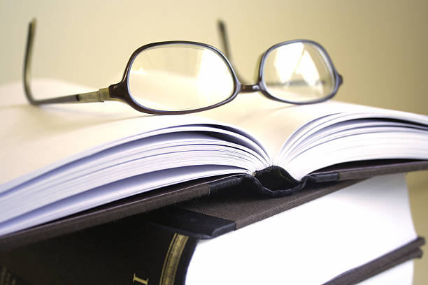 istock Pair of glasses resting on open book 144211738