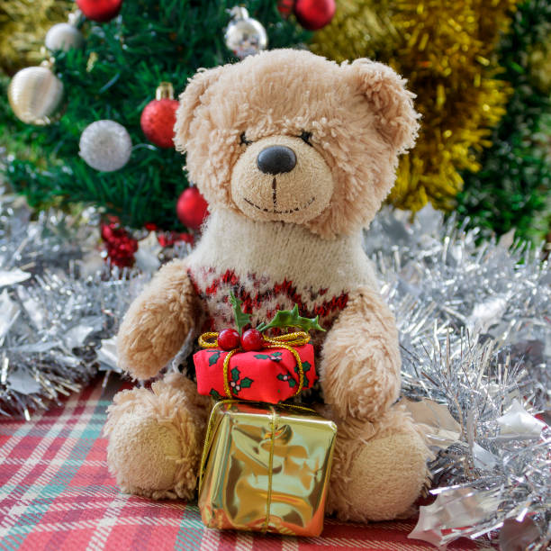 istock Small teddy bear in front of Christmas tree 1442117650