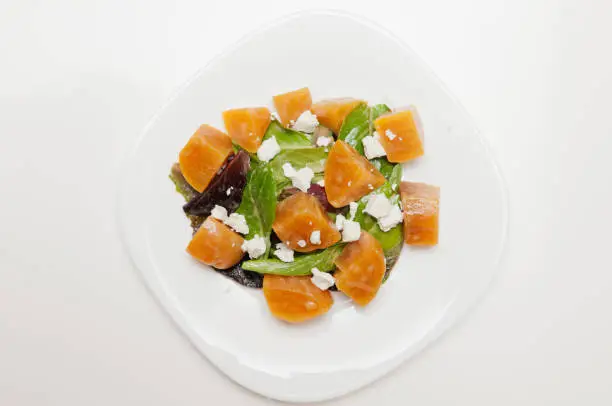 A top view of a tasty salad with golden beet, lettuce, and feta cheese