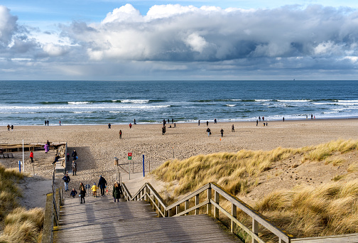 den haag, Netherlands – March 08, 2021: A Sunday afternoon walk on the Kijkduin beach of The Hague in January