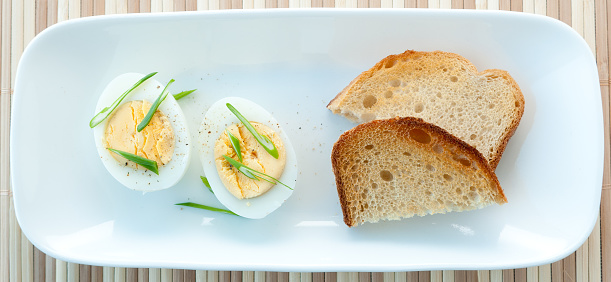 boiled egg with sliced onion and sourdough toast